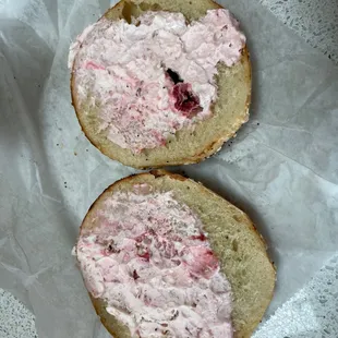 a bagel with a strawberry spread on it