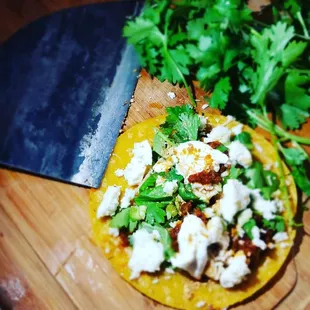 a taco on a cutting board with a knife