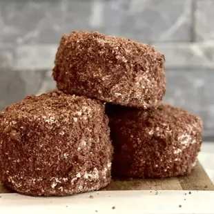 a pile of doughnuts on a cutting board