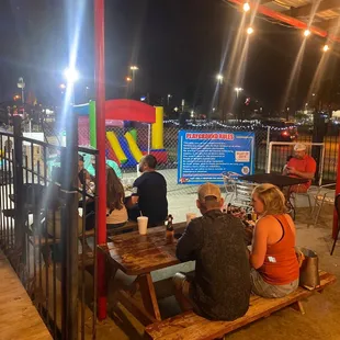 people sitting at picnic tables