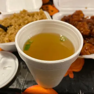 a cup of soup and a plate of food