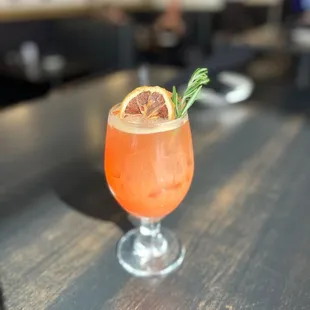 a drink with a garnish garnish
