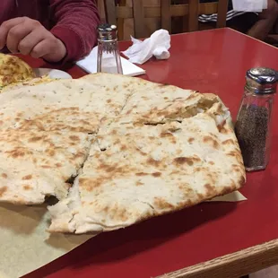 Their huge naan next to the pepper shaker