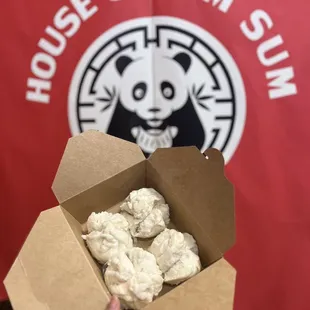 a person holding a box of food