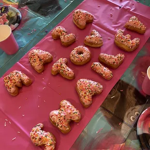 a table with a pink tablecloth and a pink table cloth