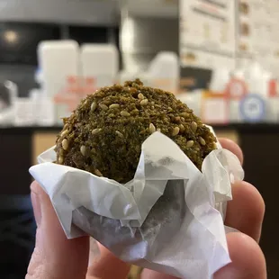 a hand holding a muffin