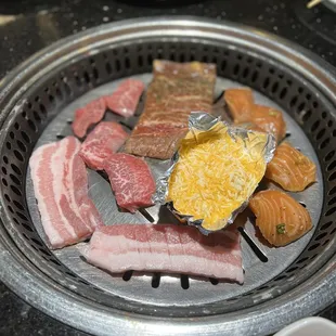 a variety of meats on a grill