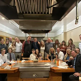 a large group of people in a kitchen