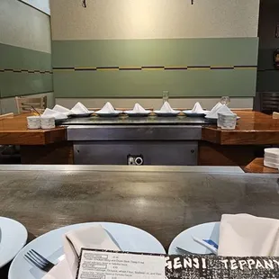 a restaurant counter with plates and napkins