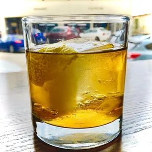 a glass of whiskey on a table