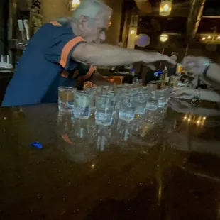 a man pouring water into a glass