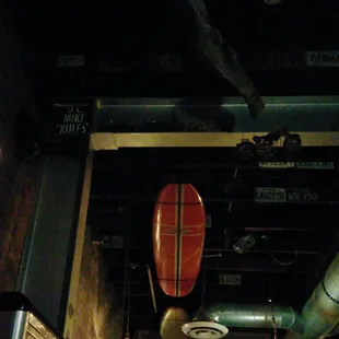 Ceiling has surfboards and license plates