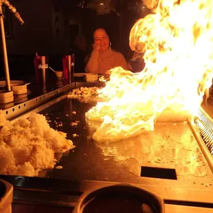 a man sitting in front of a fire