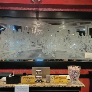 a restaurant counter with a chandelier in the background