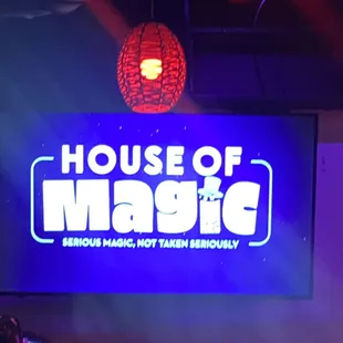 a neon sign in front of a stage