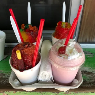 two cups of ice cream with strawberries and gummy bears