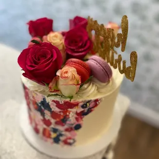 a cake with roses and macaroons