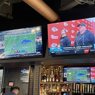 a man watching a football game on television