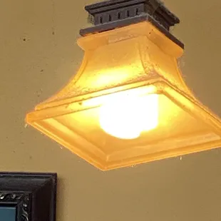 Light fixture above front counter, caked in a lot of dust.