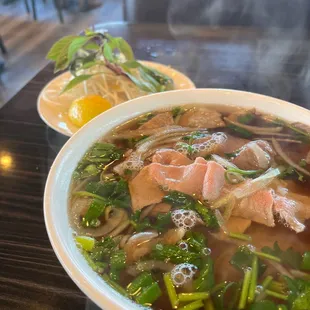 a bowl of soup with meat and vegetables