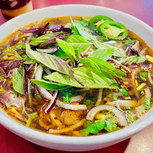 a bowl of soup with meat and vegetables