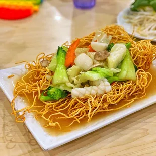 a plate of noodles and vegetables