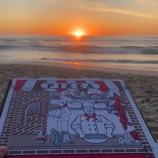 a pizza box on the beach