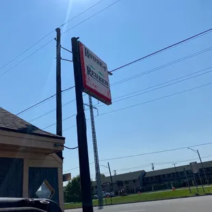 a sign on a pole in front of a building