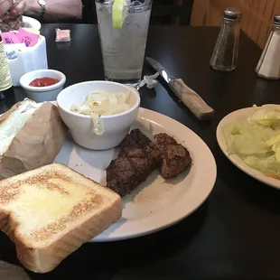 Ribeye steak lunch special comes with one side and bread. Salad extra and only available via salad bar