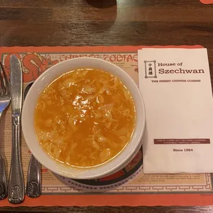 a bowl of soup on a place mat