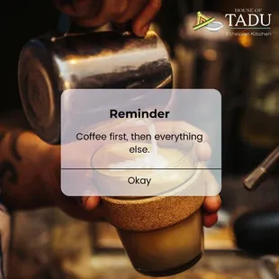 a person pouring a cup of coffee