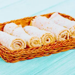 a basket of rolls of food