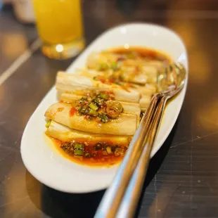 a plate of food with a fork and a glass of orange juice