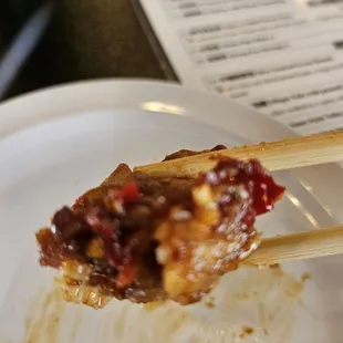 Bite of the chicken pot stickers and the amazing sauce on it!