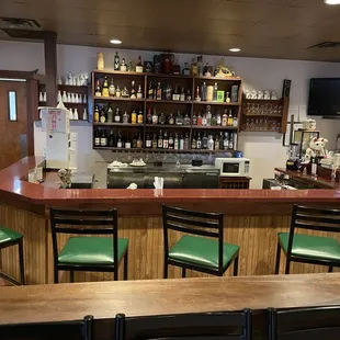 a bar with green chairs