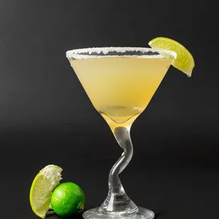 a margarita in a glass with a lime wedge