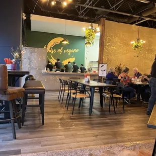 people sitting at tables in a restaurant