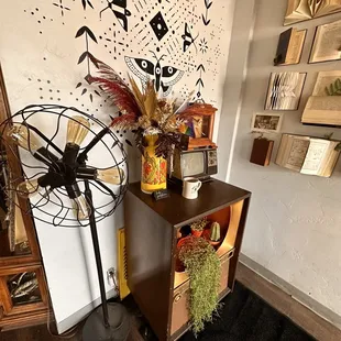 a table with a fan and a vase of flowers