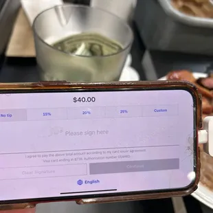 Checking out on the cashier&apos;s cell phone