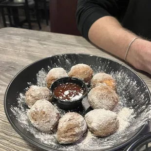 a plate of doughnuts and dipping sauce