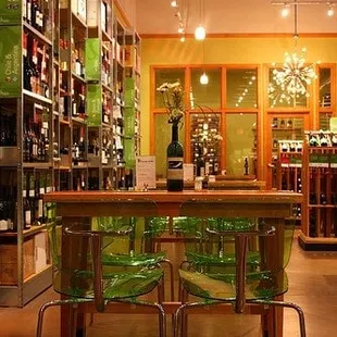 a wine shop with green chairs