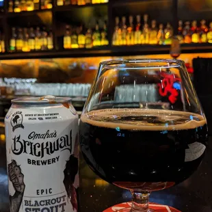 a glass of beer and a can