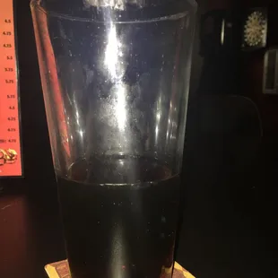 a drink in a glass on a coaster