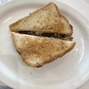 a half eaten sandwich on a plate