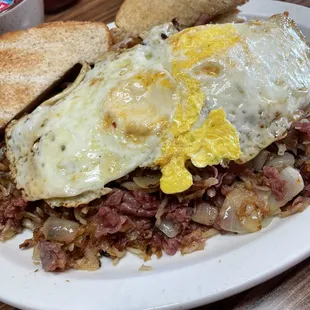 Corned beef hash and eggs over hard.