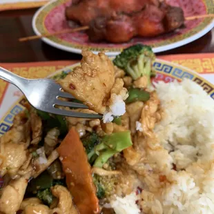 Garlic chicken with steamed rice and chicken on a stick