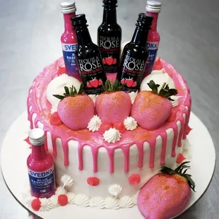 a cake decorated with pink frosting and strawberries