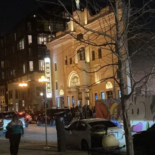 a woman walking down the street at night