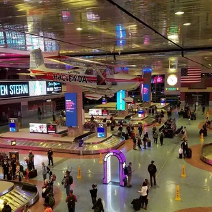 Towering above the baggage claims is the World Endurance Flight. It is the airplane that says "Hacienda."