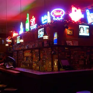 a bar with neon signs